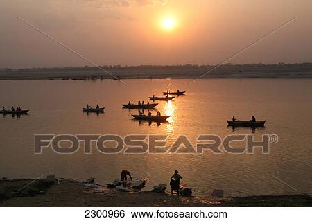 Boats on River Ganges, and clothes being washed, at sunrise. The culture of Varanasi is closely associated with the River Ganges and the river's religious importance. It is 'the religious capital of India'and an important pilgrimage destination. Varanasi View Large Photo Image Stock Photograph - Boats on River Ganges, and clothes being washed, at sunrise. The culture of Varanasi is closely associated with the River Ganges and the river's religious importance. It is 'the religious capital of India'and an important pilgrimage destination. Varanasi. Fotosearch