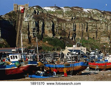 Stock Image - Boats On Rocky Beach At Hastings. Fotosearch