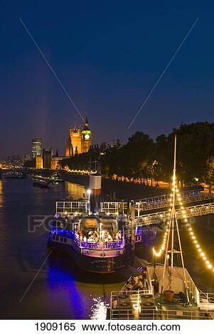 Boats On Thames River Illuminated At Night, London, England, Uk View Large Photo Image Stock Photography - Boats On Thames River Illuminated At Night, London, England, Uk. Fotosearch