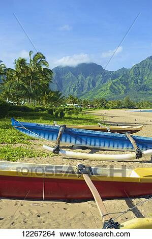 Picture - Boats on the beach with mountains in the background, Hanalei Bay; Kauai, Hawaii, United States of America. Fotosearch