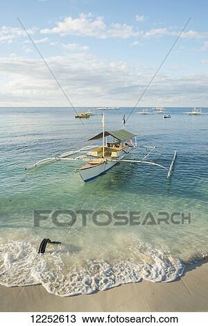 Boats on the crystal waters of Alona Beach; Panglao island, Bohol, Philippines View Large Photo Image Stock Image - Boats on the crystal waters of Alona Beach; Panglao island, Bohol, Philippines. Fotosearch