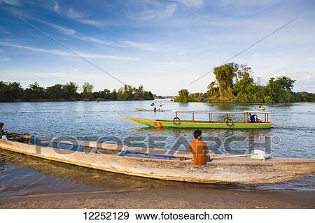 Stock Photo - Boats on the Mekong River; Island of Don Det, Laos. Fotosearch