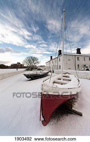 Boats Sitting On A Snow Covered Surface With A Building In The Background; South Shields, Tyne And Wear, England View Large Photo Image Stock Image - Boats Sitting On A Snow Covered Surface With A Building In The Background; South Shields, Tyne And Wear, England. Fotosearch