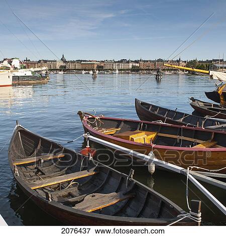 Boats Tied To A Dock With Buildings In Background View Large Photo Image Stock Photo - Boats Tied To A Dock With Buildings In Background. Fotosearch