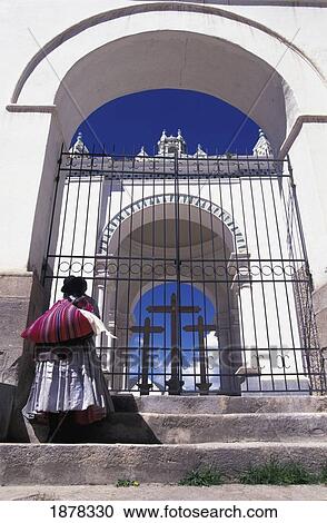 Stock Image - Bolivian Woman Outside Cathedral Gates. Fotosearch
