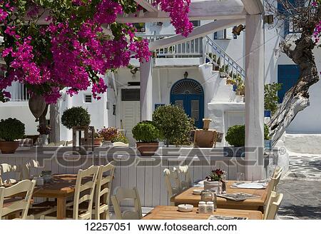 Stock Image - Bougainvillea growing around a taverna; Mykonos Town, Mykonos, Cyclades, Greek Islands, Greece. Fotosearch