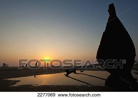 Bow of old boat on beach at dusk; Goa, India View Large Photo Image Stock Photo - Bow of old boat on beach at dusk; Goa, India. Fotosearch