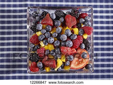 Bowl of fresh fruit including blueberries, raspberries, strawberries, blackberries and peaches with a slice of tomato; Ontario, Canada View Large Photo Image Stock Photo - Bowl of fresh fruit including blueberries, raspberries, strawberries, blackberries and peaches with a slice of tomato; Ontario, Canada. Fotosearch