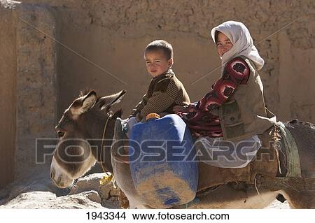 Picture - Boy And Girl On A Donkey In Bamiyan, Bamian Province, Afghanistan. Fotosearch