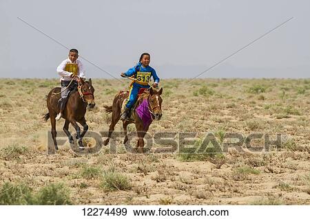 Stock Photo - Boy and girl riding horses in the Daaga (two-year old) horse race held during the Naadam Festival in Mandal Ovoo,? mnÃƒÆ’Ã‚Â·govi Province, Mongolia. Fotosearch