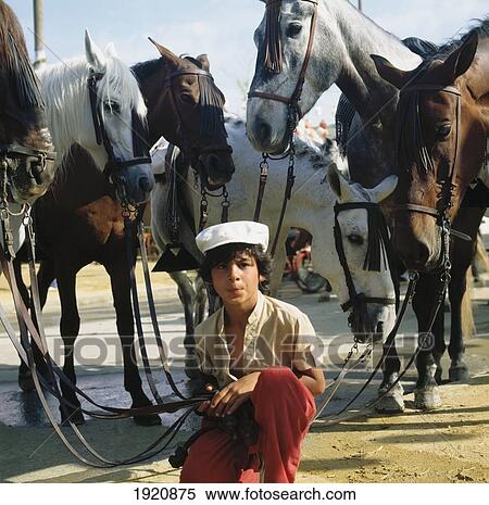Stock Photography - Boy And Horses During Feria. Fotosearch