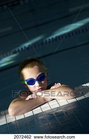 Stock Image - Boy At Pool Edge Wearing Swim Goggles. Fotosearch