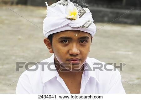 Stock Image - Boy at Pura Luhur Pucak Sari Temple, Bedugul, Bali, Indonesia. Fotosearch