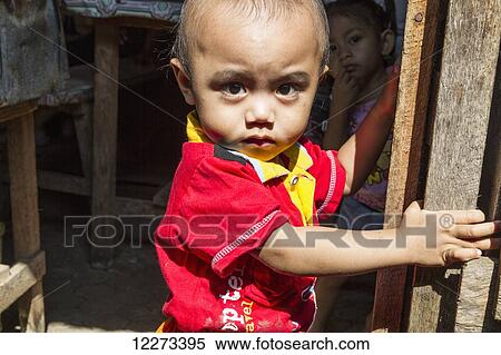 Boy at the Bolu market, Makassar (Ujung Pandang), South Sulawesi, Indonesia View Large Photo Image Stock Photography - Boy at the Bolu market, Makassar (Ujung Pandang), South Sulawesi, Indonesia. Fotosearch