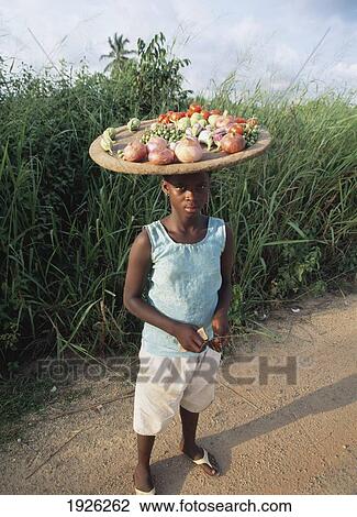 Boy Carrying Fruit On His Head View Large Photo Image Stock Image - Boy Carrying Fruit On His Head. Fotosearch