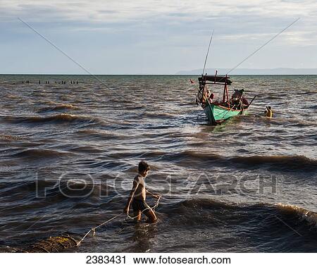 Boy collecting crab traps; Kep, Cambodia View Large Photo Image Stock Image - Boy collecting crab traps; Kep, Cambodia. Fotosearch