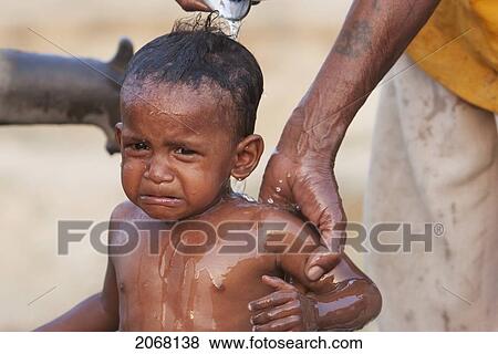Stock Photo - Boy Getting A Bath At The Well, Rajgir, Bihar, India. Fotosearch