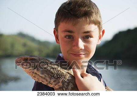 Boy holding a lizard; Thaton, Chiang Rai, Thailand View Large Photo Image Stock Image - Boy holding a lizard; Thaton, Chiang Rai, Thailand. Fotosearch