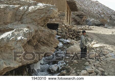 Stock Image - Boy Holding An Icicle In Aab-E-Noraq, Bamian Province, Afghanistan. Fotosearch
