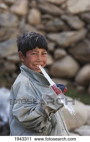 Stock Image - Boy Holding An Icicle In Aab-E-Noraq, Bamian Province, Afghanistan. Fotosearch