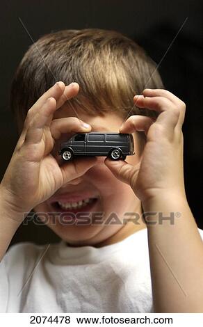 Boy Holding Toy Car In Front Of Face View Large Photo Image Stock Photo - Boy Holding Toy Car In Front Of Face. Fotosearch