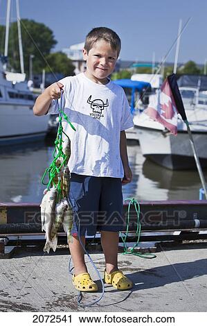 Boy Holding Up Fish, Caught In Lake Winnipeg, Gimli, Manitoba View Large Photo Image Stock Image - Boy Holding Up Fish, Caught In Lake Winnipeg, Gimli, Manitoba. Fotosearch