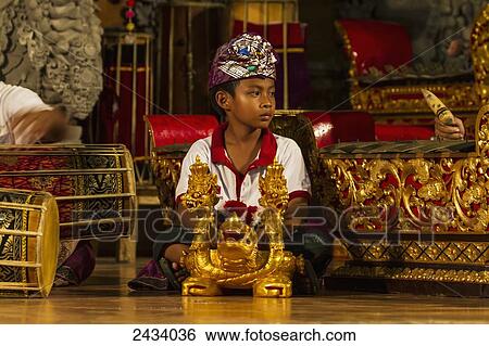 Stock Photograph - Boy in a gamelan orchestra, Ubud, Bali, Indonesia. Fotosearch