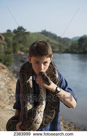 Boy kissing a python; Thaton, Chiang Rai, Thailand View Large Photo Image Stock Photo - Boy kissing a python; Thaton, Chiang Rai, Thailand. Fotosearch