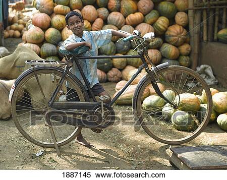 Boy Leaning Against Bicycle Infront Of Pumpkins View Large Photo Image Stock Photography - Boy Leaning Against Bicycle Infront Of Pumpkins. Fotosearch