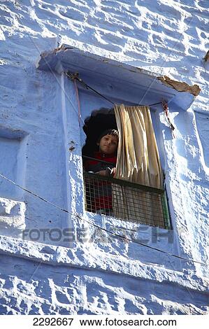 Boy looking out of a window in Blue Town of Jodphur Rajasthan India View Large Photo Image Stock Photo - Boy looking out of a window in Blue Town of Jodphur Rajasthan India. Fotosearch