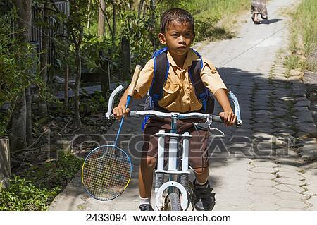 Picture - Boy on a bicycle, Sei Sekonyer, Central Kalimantan, Borneo, Indonesia. Fotosearch