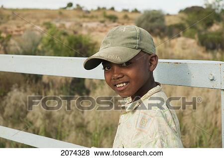 Boy On A Bridge Over The Maninday River, Toliara Province, Madagascar View Large Photo Image Stock Photo - Boy On A Bridge Over The Maninday River, Toliara Province, Madagascar. Fotosearch