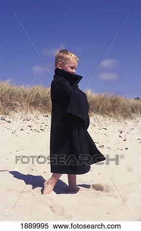 Boy On Beach Wrapped In Coat View Large Photo Image Stock Photography - Boy On Beach Wrapped In Coat. Fotosearch