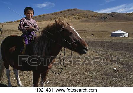 Stock Image - Boy On Horse With Yurt. Fotosearch