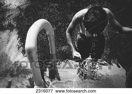 Boy On Swimming Pool Steps Head Down And Dripping Water; Otterburn Park Quebec Canada View Large Photo Image Stock Photo - Boy On Swimming Pool Steps Head Down And Dripping Water; Otterburn Park Quebec Canada. Fotosearch