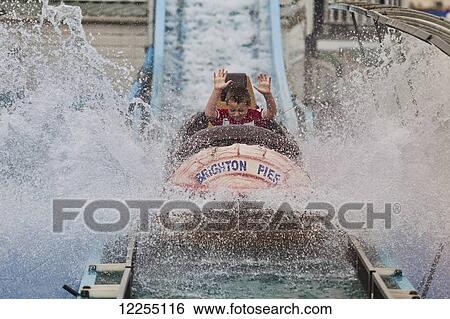 Stock Photograph - Boy on the log flume, Brighton Pier; Brighton, England. Fotosearch