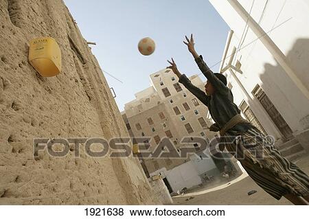 Boy Playing Basketball In Shibam View Large Photo Image Stock Photo - Boy Playing Basketball In Shibam. Fotosearch