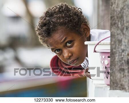 Stock Image - Boy, Pulao Asei, island in Lake Sentani, Papua, Indonesia. Fotosearch