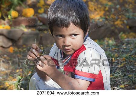 Picture - Boy Sitting On A Grave During The Celebration Of D. Fotosearch