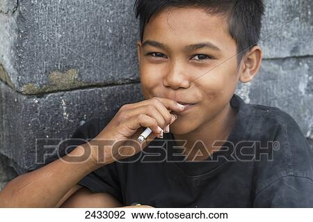 Boy smoking a cigarette, Prambanan, Central Java, Indonesia View Large Photo Image Stock Image - Boy smoking a cigarette, Prambanan, Central Java, Indonesia. Fotosearch