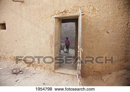 Boy standing in courtyard at Djenne, Mali View Large Photo Image Stock Photo - Boy standing in courtyard at Djenne, Mali. Fotosearch