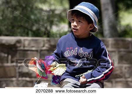 Stock Photo - Boy Watching The Entrada De Comadritas Parade During The Carnaval Chapaco, Tarija, Bolivia. Fotosearch