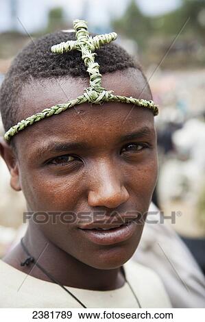 Boy wearing a traditional grass headband to celebrate Orthodox Easter; Lalibela, Ethiopia View Large Photo Image Stock Photo - Boy wearing a traditional grass headband to celebrate Orthodox Easter; Lalibela, Ethiopia. Fotosearch