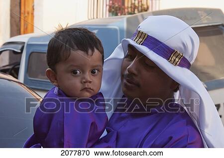 Stock Image - Boy Wearing Purple As A Sign Of Mourning At The Procession Of The Holy Cross On Good Friday In Antigua Guatemala, Sacatep. Fotosearch