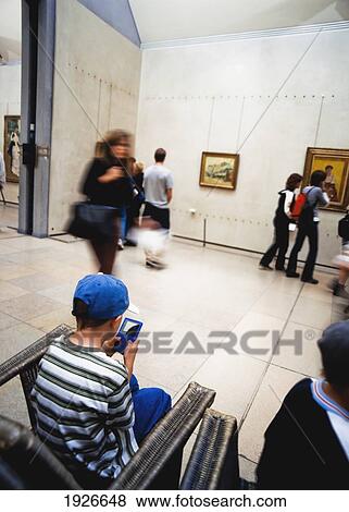 Stock Photo - Boy With 'gameboy' In Musee D'orsay. Fotosearch