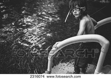Boy With Swimming Goggles On Pool Steps Looking Anxious To Go In; Otterburn Park Quebec Canada View Large Photo Image Picture - Boy With Swimming Goggles On Pool Steps Looking Anxious To Go In; Otterburn Park Quebec Canada. Fotosearch