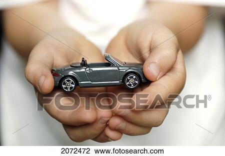 Stock Image - Boy With Toy Car In Hands. Fotosearch