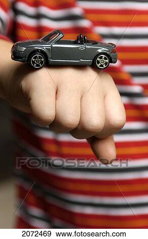 Stock Photo - Boy With Toy Car On His Fist. Fotosearch