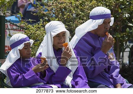 Boys And Man Wearing Purple As A Sign Of Mourning, Whilst Having An Ice Cream At The Procession Of The Holy Cross On Good Friday In Antigua Guatemala, Sacatep View Large Photo Image Stock Image - Boys And Man Wearing Purple As A Sign Of Mourning, Whilst Having An Ice Cream At The Procession Of The Holy Cross On Good Friday In Antigua Guatemala, Sacatep. Fotosearch