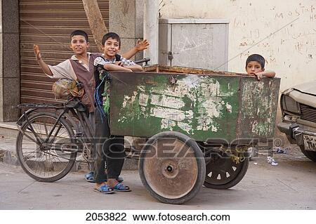 Stock Image - Boys By A Tricycle, Cairo, Al Qahirah, Egypt. Fotosearch